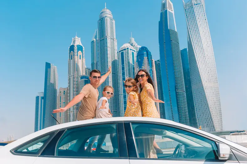 Famille en voiture lors d'un voyage estival à Dubaï – déménager à Dubaï